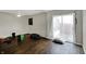 Living room with wood-look flooring and sliding glass door at 7212 E Pleasant Run Pkwy S Dr, Indianapolis, IN 46219