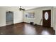 Inviting living room with hardwood floors, white walls, a ceiling fan, and a large window at 7212 E Pleasant Run Pkwy S Dr, Indianapolis, IN 46219