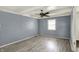 Open living room features wood floors and a ceiling fan at 7212 E Pleasant Run Pkwy S Dr, Indianapolis, IN 46219