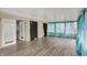 Bright sunroom features wood floors and many windows with curtains at 7212 E Pleasant Run Pkwy S Dr, Indianapolis, IN 46219