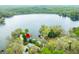 Aerial view of a lakeside home surrounded by mature trees, near a lake and forest at 7456 Heather Ct, Nineveh, IN 46164