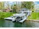 Aerial view of home featuring a white deck with a boat lift on the water at 7456 Heather Ct, Nineveh, IN 46164