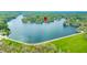Aerial view showing a lake surrounded by homes, docks, and lush trees at 7456 Heather Ct, Nineveh, IN 46164