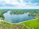 Aerial view of a lake surrounded by dense forests and residential properties at 7456 Heather Ct, Nineveh, IN 46164