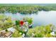 Aerial view of a lakeside home with a dock and waterfront access to a clear lake surrounded by lush trees at 7456 Heather Ct, Nineveh, IN 46164
