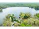 Aerial view of a lakeside home surrounded by mature trees, near a lake and forest at 7456 Heather Ct, Nineveh, IN 46164