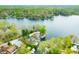 Aerial view of a lakeside home with a dock and waterfront access to a clear lake surrounded by lush trees at 7456 Heather Ct, Nineveh, IN 46164