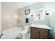 Bathroom featuring a tiled shower, toilet, vanity, and fixtures with natural light and blue walls at 7456 Heather Ct, Nineveh, IN 46164