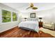 Bright bedroom showcasing hardwood floors, a ceiling fan, a comfortable bed, and bright windows at 7456 Heather Ct, Nineveh, IN 46164