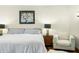 Bedroom features hardwood floors, a comfortable bed, a chair and side table, and decorative wall art at 7456 Heather Ct, Nineveh, IN 46164