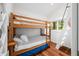 Bright bedroom featuring wooden bunk beds, hardwood floors, and a ladder at 7456 Heather Ct, Nineveh, IN 46164