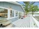 Deck with grill, orange chairs, and outdoor seating area with lake views at 7456 Heather Ct, Nineveh, IN 46164
