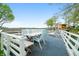 Waterfront deck featuring lounge chairs, dining area and beautiful lake views at 7456 Heather Ct, Nineveh, IN 46164