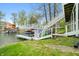 Scenic view of a waterfront home with a private boat dock and covered boat lift at 7456 Heather Ct, Nineveh, IN 46164