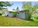 Side view of home with natural landscaping and a deck on the water at 7456 Heather Ct, Nineveh, IN 46164
