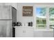Well lit kitchen with breakfast nook, white cabinets, and stainless steel fridge at 7456 Heather Ct, Nineveh, IN 46164