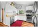 Modern kitchen with white cabinets, stainless steel appliances, and wood floors at 7456 Heather Ct, Nineveh, IN 46164