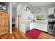 Bright kitchen with stainless steel appliances, white cabinets and wood floors at 7456 Heather Ct, Nineveh, IN 46164