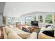 Bright living room features hardwood floors, comfortable couches, natural light, and a table with a board game at 7456 Heather Ct, Nineveh, IN 46164