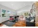 Bright open-concept living room features hardwood floors, a vaulted ceiling, and expansive windows offering scenic water views at 7456 Heather Ct, Nineveh, IN 46164