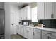 Modern kitchen features white cabinets, quartz countertops, sleek hardware, and stainless steel appliances at 769 Rose Garden Way, Westfield, IN 46074