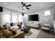 Bright living room with a white sofa, modern furniture, and a decorative accent wall at 769 Rose Garden Way, Westfield, IN 46074