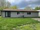 Rear exterior of house with gray siding and sliding glass door to backyard at 7833 Broadview Dr, Indianapolis, IN 46227