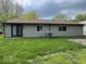 Rear exterior of house with gray siding and sliding glass door to backyard at 7833 Broadview Dr, Indianapolis, IN 46227