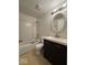 Bathroom featuring vanity with dark cabinet, white toilet, and shower-tub combo at 7833 Broadview Dr, Indianapolis, IN 46227