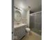 Bathroom with shower, toilet and vanity with oval mirror and overhead lighting at 7833 Broadview Dr, Indianapolis, IN 46227