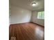 Bedroom with hardwood flooring, window and white door at 7833 Broadview Dr, Indianapolis, IN 46227