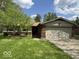 Charming single-story home features a brick facade and an attached two-car garage at 7833 Broadview Dr, Indianapolis, IN 46227