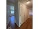 Hallway featuring 6-panel door, closet, and door leading to room with window at 7833 Broadview Dr, Indianapolis, IN 46227