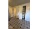 Bright hallway with ample storage featuring a large pantry and patterned tile flooring at 7833 Broadview Dr, Indianapolis, IN 46227