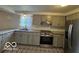 Contemporary kitchen featuring granite countertops, stainless steel appliances, and stylish gray cabinets at 7833 Broadview Dr, Indianapolis, IN 46227