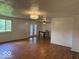 The living room boasts hardwood floors and a chandelier with a window view of the yard at 7833 Broadview Dr, Indianapolis, IN 46227