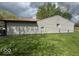 The side exterior of a house with gray siding and a well-maintained lawn at 7833 Broadview Dr, Indianapolis, IN 46227