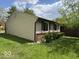Angled house exterior featuring brick and gray siding with green grass at 7833 Broadview Dr, Indianapolis, IN 46227