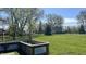Backyard with a lush green lawn, a scarecrow, and garden beds in a tranquil setting at 8200 E Desoto St, Muncie, IN 47303