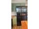 Spacious kitchen with modern stainless steel refrigerator and light green cabinets at 8200 E Desoto St, Muncie, IN 47303
