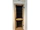 Rustic wood pantry door with decorative iron hardware and glass panels at 8200 E Desoto St, Muncie, IN 47303