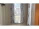 Bright room with views to the exterior is lit through a set of windows with branch patterned curtains at 8200 E Desoto St, Muncie, IN 47303