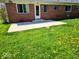 Backyard featuring a concrete patio and a lush green lawn, perfect for outdoor seating and relaxation at 8230 E 11Th St, Indianapolis, IN 46219