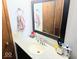 Bathroom featuring a sink and mirror at 8230 E 11Th St, Indianapolis, IN 46219
