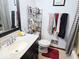 Well-lit bathroom featuring a clean sink, toilet, and shower/tub combination at 8230 E 11Th St, Indianapolis, IN 46219
