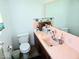 Clean bathroom with pink sink and countertop at 8230 E 11Th St, Indianapolis, IN 46219