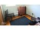 Bedroom featuring a modern TV, dresser, stool and neutral-toned walls at 8230 E 11Th St, Indianapolis, IN 46219