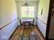 Cozy dining nook featuring hardwood floors, a window, and a wooden table with chairs at 8230 E 11Th St, Indianapolis, IN 46219
