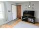 Bright entryway featuring hardwood floors, a white door, and decoratively arranged wall mirrors at 8230 E 11Th St, Indianapolis, IN 46219