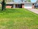 Well-maintained home with a tidy front lawn and an attached garage, providing convenience and curb appeal at 8230 E 11Th St, Indianapolis, IN 46219